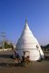 Thailand: A samlor rides passed the White Chedi near Chiang Mai’s municipal hall on the Ping River